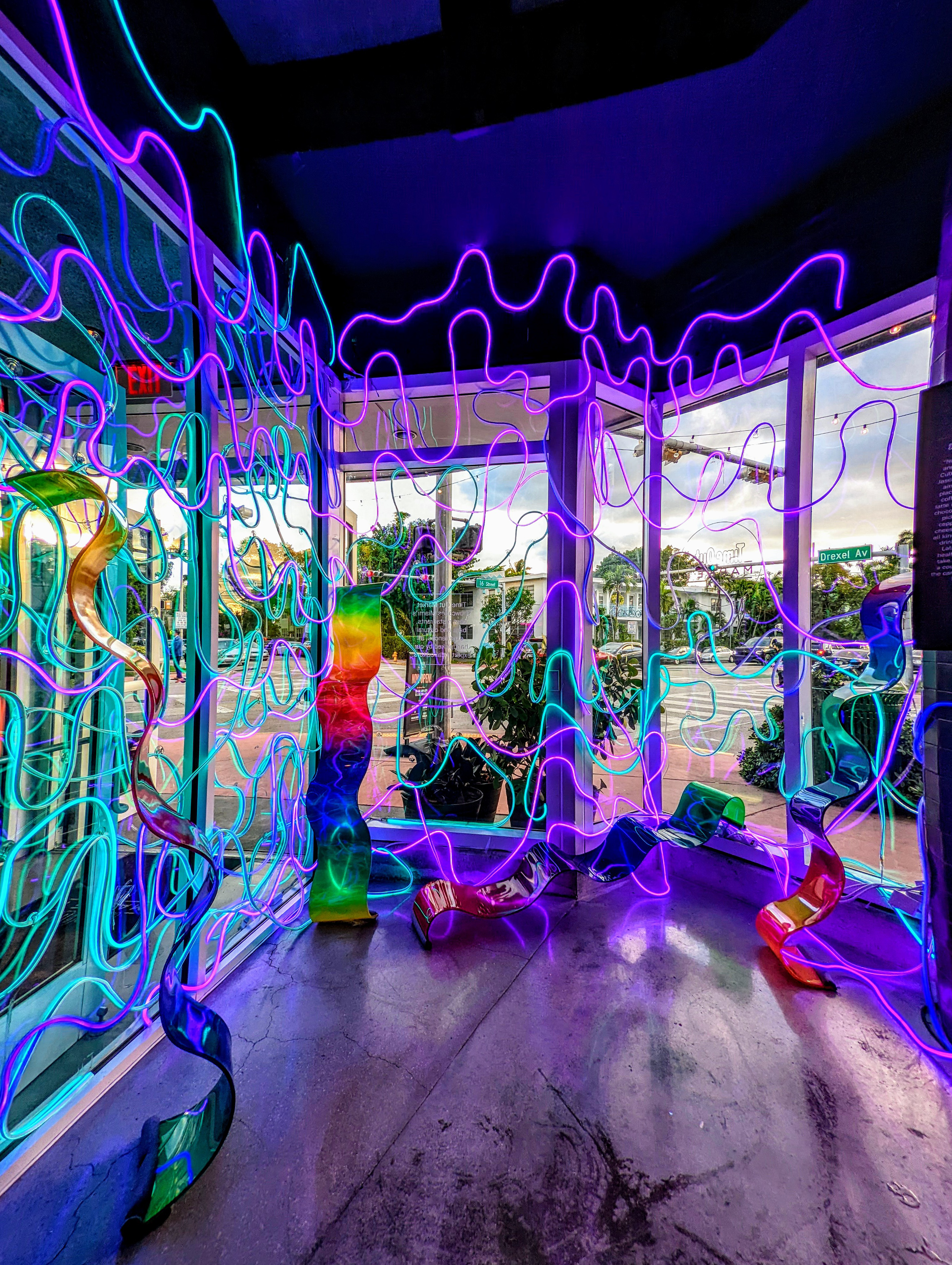 Colorful LED wave installation by Haiiileen at TimeOut Market Miami, featuring glowing sculptural ribbons and vibrant neon lines.