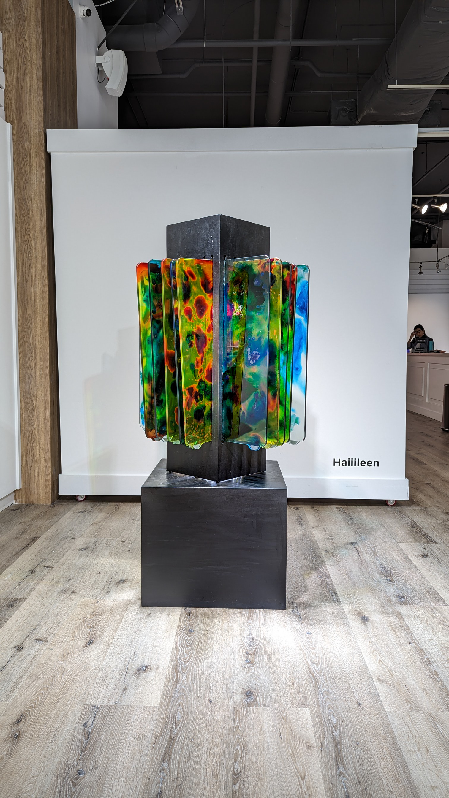 re-re (2023) by Haiiileen – upcycled glass and wood sculpture installed at Doral Contemporary Art Museum, reflecting light through vibrant chemical-treated panels.