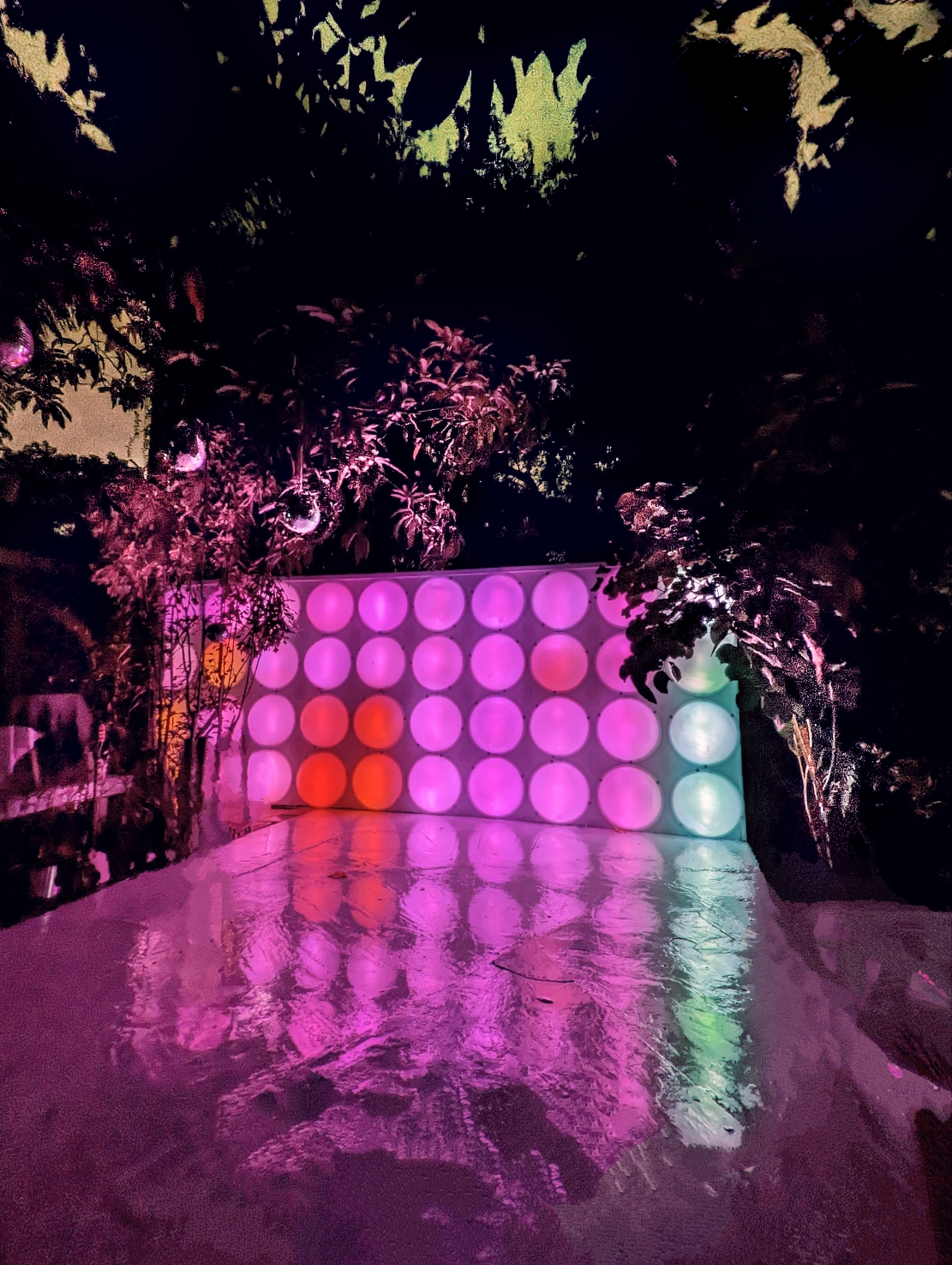 Bubble (2022) by Haiiileen – large-scale outdoor installation of forty illuminated acrylic domes glowing in pink, violet, and blue light.